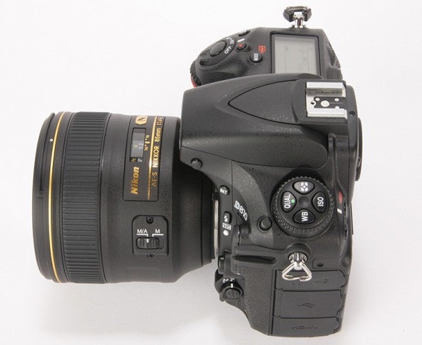 Professional DSLR camera with telephoto lens on white background.