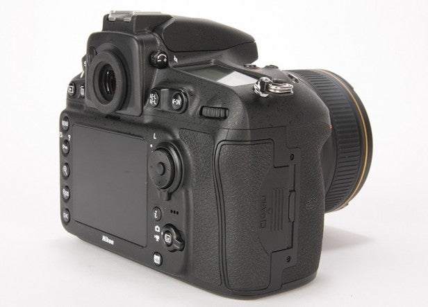 Nikon D810 DSLR camera with lens on white background.