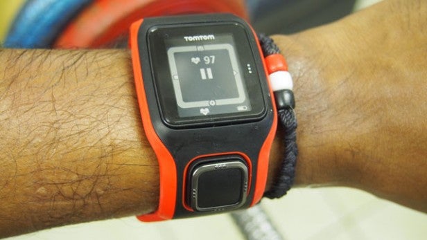 TomTom Runner Cardio watch displaying heart rate on wrist.