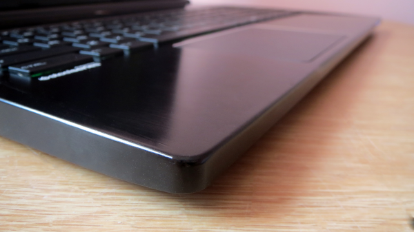 Close-up of MSI GS60 2PE Ghost Pro laptop on a wooden desk.
