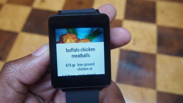 Hand holding smartwatch displaying a recipe for buffalo chicken meatballs.