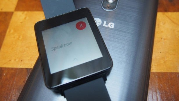 Smartwatch with voice command prompt on screen.