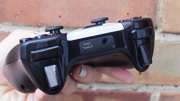 Hand holding a Shield gaming controller.