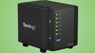 Synology DS414slim NAS device against green background.