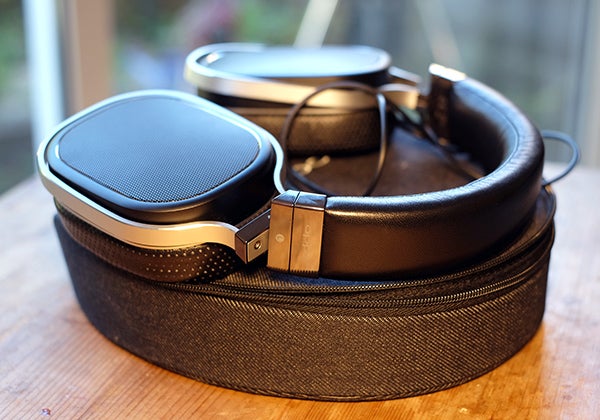 Oppo PM-1 headphones with carrying case on wooden surface.