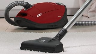 Miele Complete C3 vacuum cleaner on white carpet.