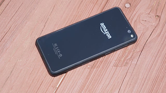 Amazon Fire Phone lying on a wooden surface.