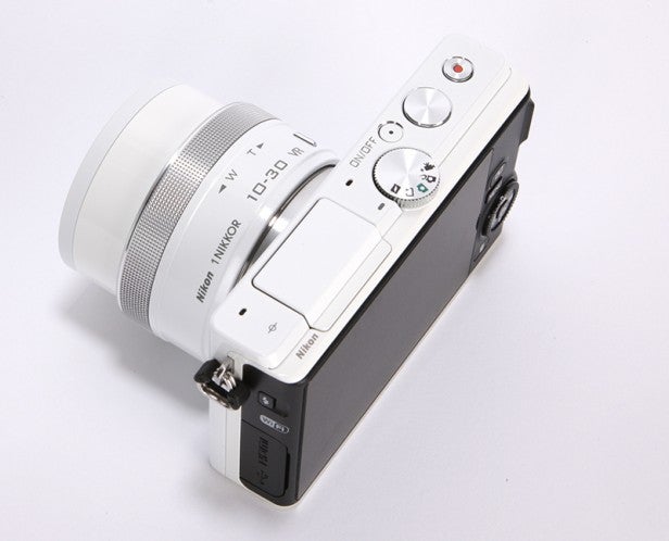 Nikon 1 J4 mirrorless camera with white lens.