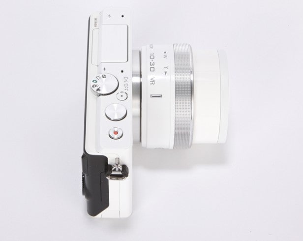 White mirrorless camera with lens viewed from the top.