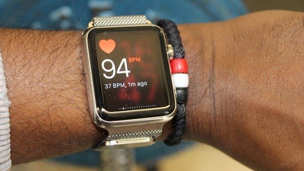 Fitness smartwatch displaying heart rate on wearer's wrist.