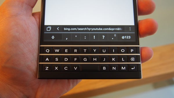 Close-up of BlackBerry Passport keyboard and screen with search bar.