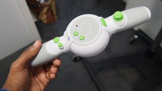Hand holding a LeapTV educational gaming controller.