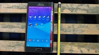 Samsung Galaxy Edge smartphone on a wooden bench beside a pencil.