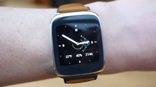 Asus ZenWatch on wrist displaying time and weather information.