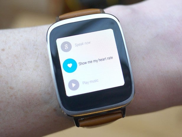 Android Wear smartwatch displaying voice command options on wrist.