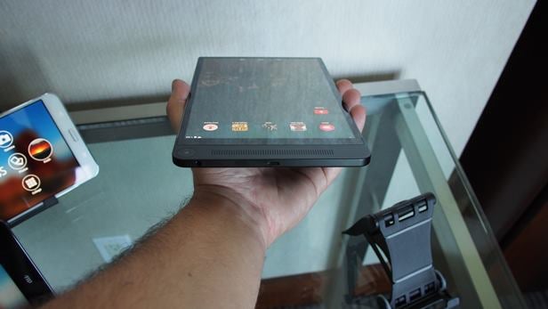 Hand holding Dell Venue 8 7000 tablet displaying apps