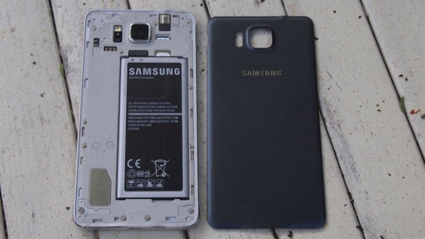 Samsung phone with battery visible next to back cover.
