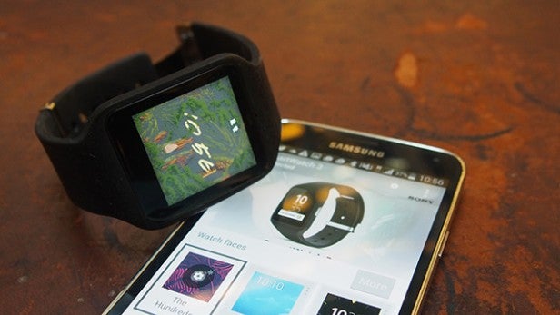 Android smartwatch displayed next to a Samsung smartphone.