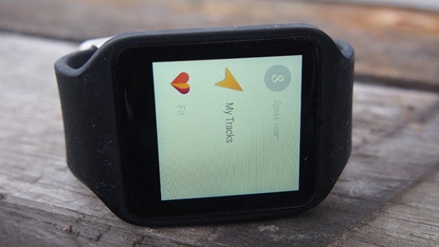 Android Wear smartwatch displaying fitness tracking apps on screen.