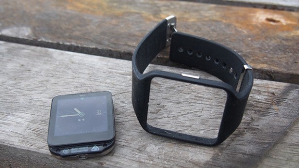 Sony SmartWatch 3 on wooden surface with detached strap.