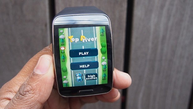 Smartwatch displaying game application on screen.