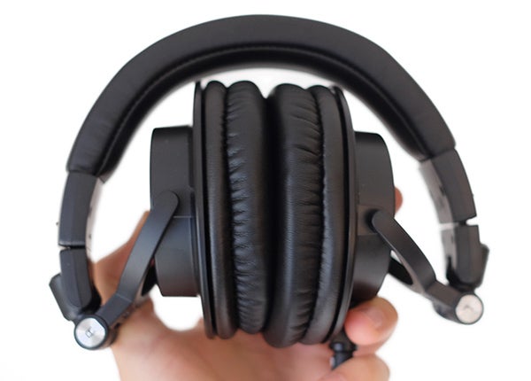Audio-Technica ATH-M50x professional studio headphones held in hand.
