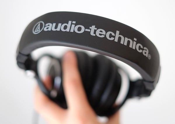 Close-up of Audio-Technica ATH-M50x headphones held in hand.