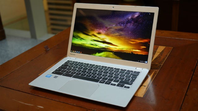 Toshiba Chromebook 2 on wooden table with screen on.
