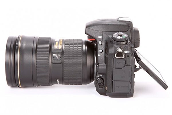 Nikon D750 DSLR camera with zoom lens on white background.
