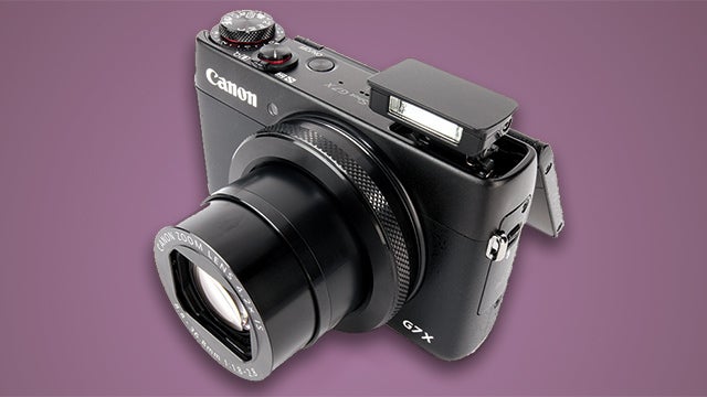 Canon PowerShot G7 X camera with lens extended and flash up.