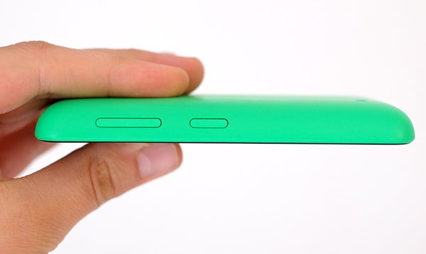 Hand holding a green Nokia Lumia 530 smartphone on its side.