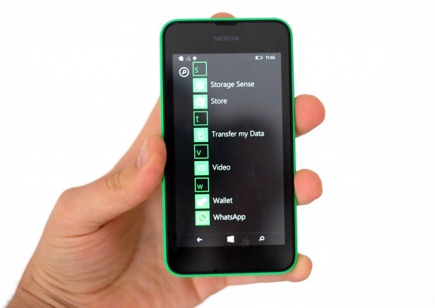 Hand holding Nokia smartphone displaying app menu.