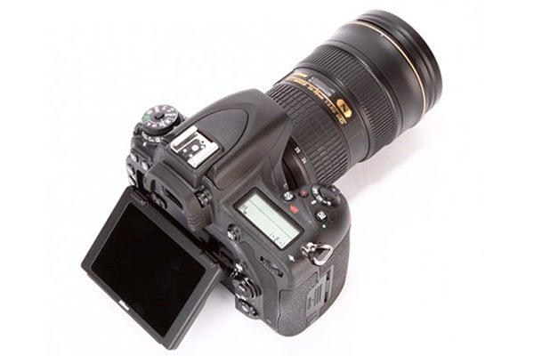 Nikon D750 DSLR camera with lens and open screen.