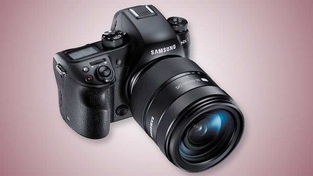 Samsung NX1 camera with lens on pink background.