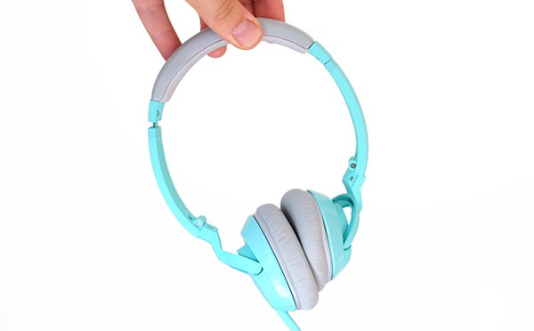 Hand holding Bose SoundTrue On-ear Headphones in teal color