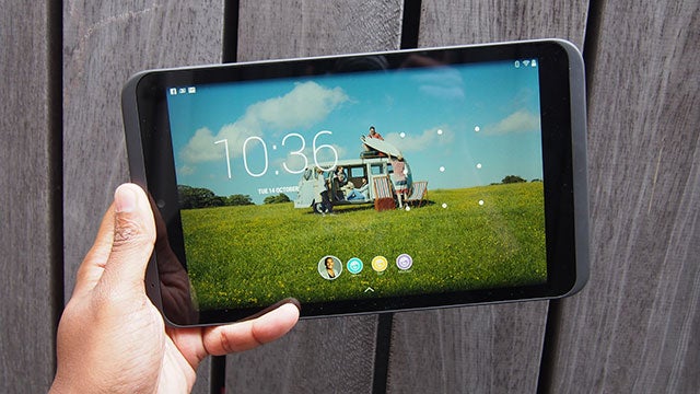 Hand holding a Tesco Hudl 2 tablet with display on.