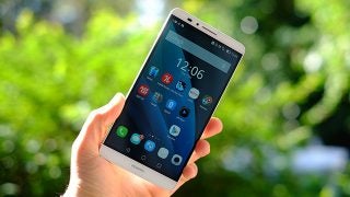 Huawei Ascend Mate 7 smartphone held in hand outdoors