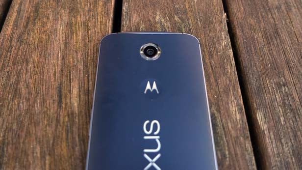 Nexus 6 smartphone back cover on a wooden surface.