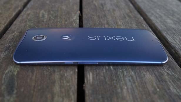 Two Nexus 6 smartphones back view on wooden surface.Nexus 6 smartphone lying on wooden surface.Nexus 6 smartphone back cover on a wooden surface.
