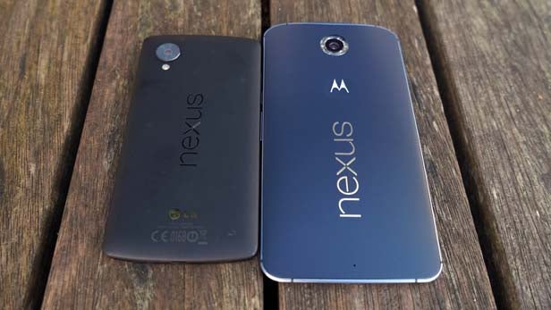 Two Nexus 6 smartphones back view on wooden surface.Nexus 6 smartphone back cover on a wooden surface.