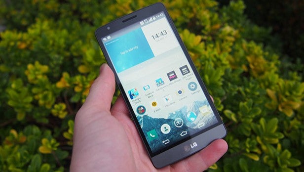 LG G3 SHand holding a smartphone with visible home screen icons.