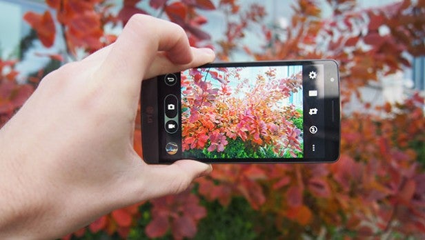 LG G3 SHand holding smartphone taking photo of colorful foliage.