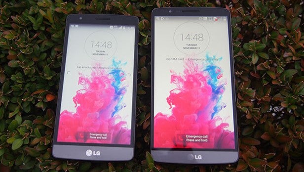LG G3 STwo smartphones with colorful wallpaper on screen displayed outdoors.
