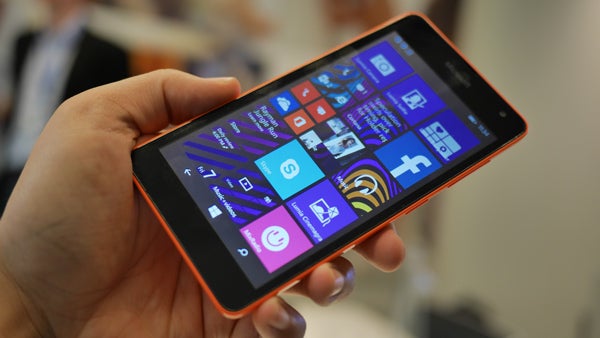 Hand holding a Microsoft Lumia 535 with screen visible