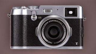 Fujifilm X100T camera on a gray background.
