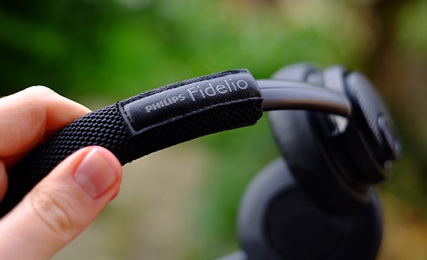 Close-up of Philips Fidelio M2BT headphone strap and earcup.
