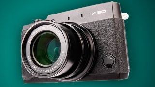 Fujifilm X30 camera against a green background.