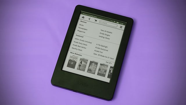Kindle e-reader displaying a list of books on screen.