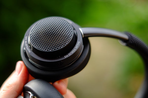 Close-up of Philips Fidelio M2BT headphones held in hand