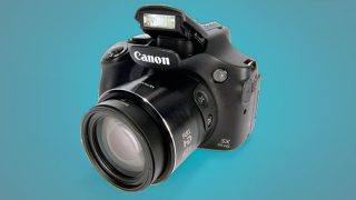 Canon PowerShot SX60 HS camera with pop-up flash activated.